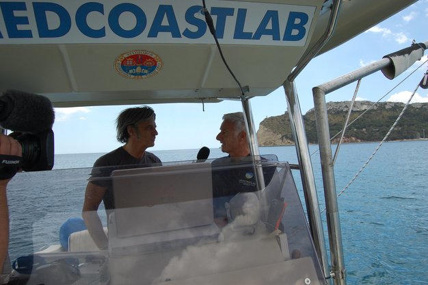 Massimo Mignanelli intervista Sandro Demuro a bordo dell'imbarcazione del CMGG (sullo sfondo, la Sella del Diavolo)