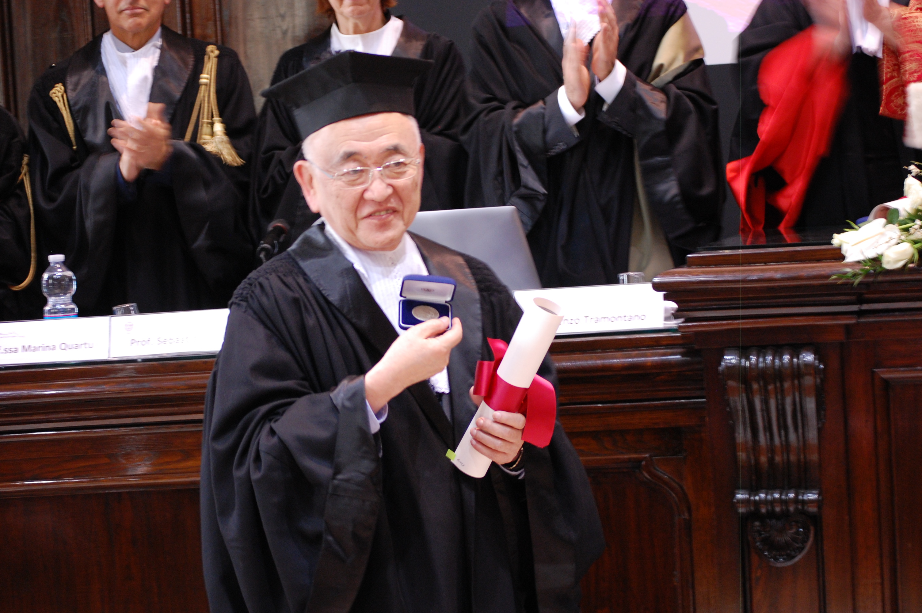 Il prof. Cheng mostra la medaglia del nostro Ateneo